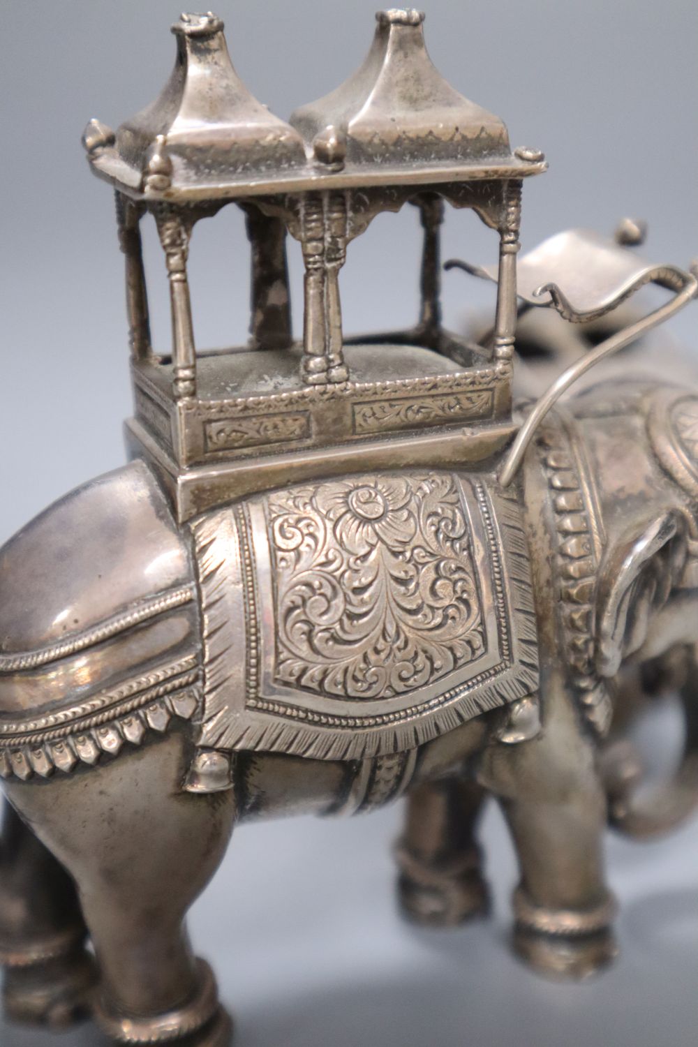 A pair of cast silver plated models of ceremonial elephants, 11cm high